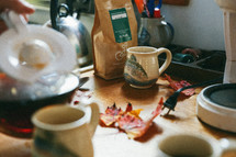 a messy counter top with coffee and coffee mugs 