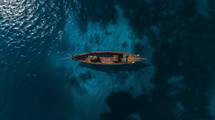 Top down view of a vintage empty boat on the blue water.