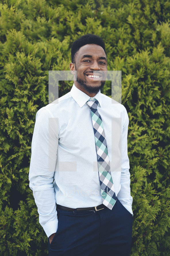 a smiling man in a tie 