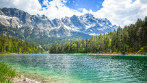 jagged mountains across a blue-green lake 