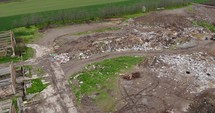  Aerial Drone Shot of Abandoned Structures Next To A Garbage Hill On Landfill.