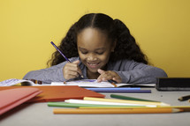 a child coloring on paper 