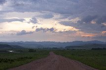 dirt road and mountains at sunset 
