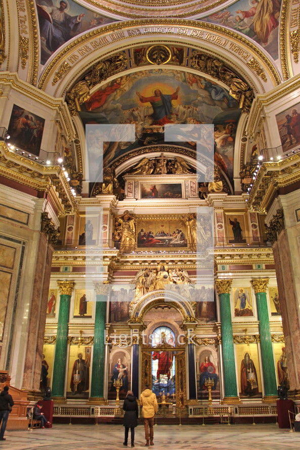 Cathedral with frescos, pillars, and stained glass.