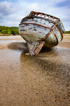 old beach boat on sand 