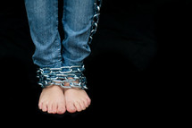 A woman with chained ankles. 