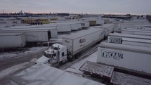 Drone shot of semi trucks at a trucking depot