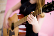 woman playing a guitar 