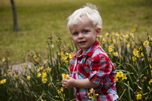 toddler boy picking daffodils 