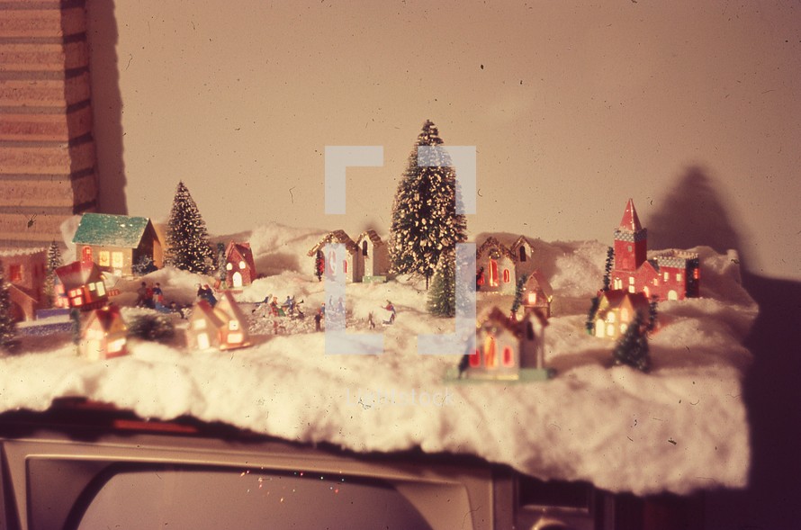 mini Christmas village on top of an old television set 