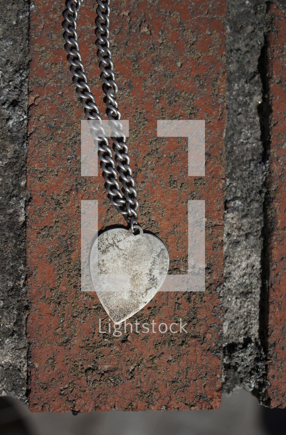 heart necklace on brick