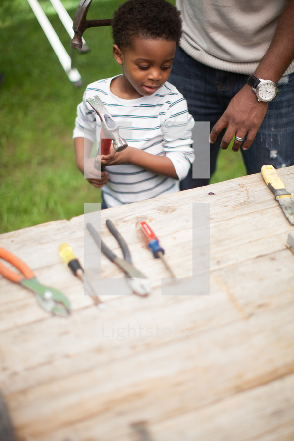 father and son using tools 