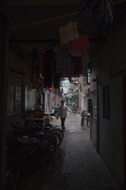 clothes hanging in a covered alley in China 