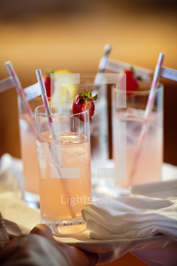 straws in glasses of strawberry lemonade