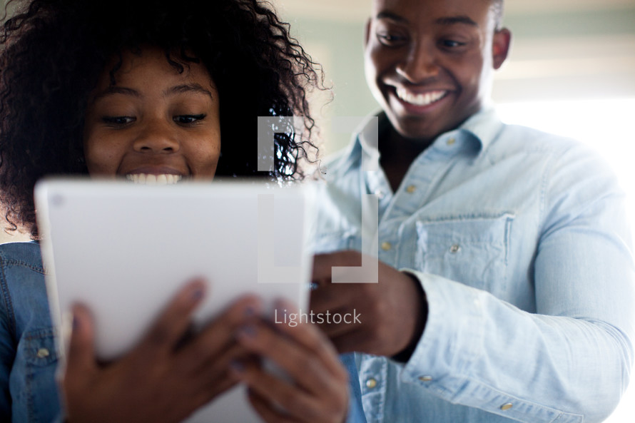 a couple looking at an iPad screen 