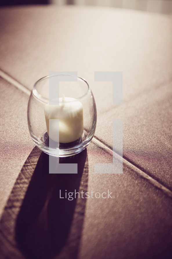 votive candle on the floor