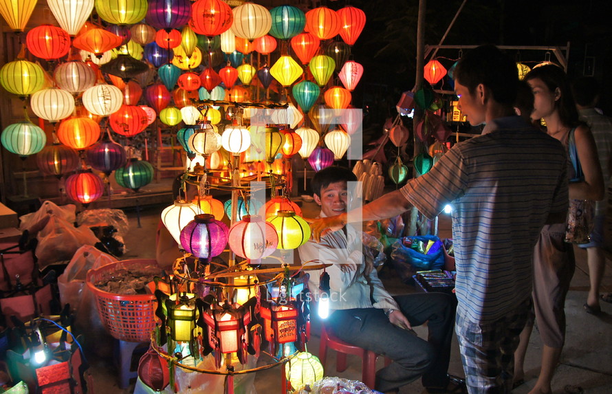 People shopping for Chinese paper lanterns