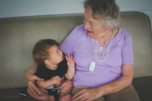a grandmother sitting with her infant grandson 