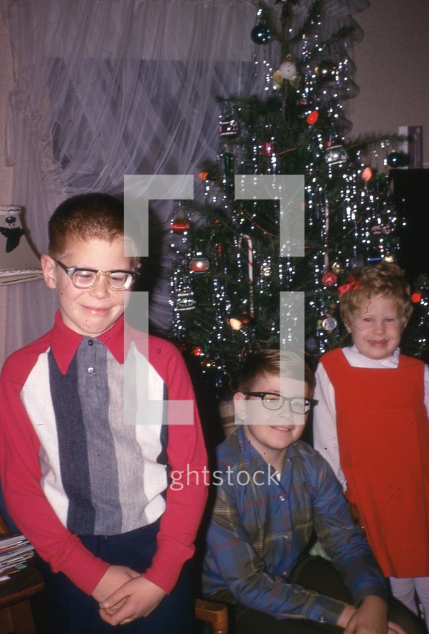 children in front of a vintage Christmas tree 