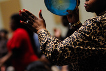 woman playing a tambourine at a worship service 
