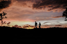 Silhouette of a couple walking during sunset