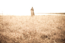 Joseph standing in a field under sunlight 