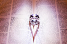 Wedding rings sitting inside of bible