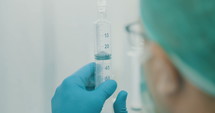 Oncology pharmacist preparing chemotherapy drugs