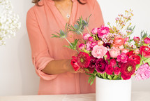 a mother arranging a bouquet of flowers 