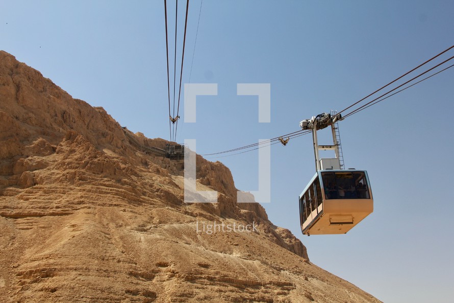 cable cars over desert landscape 