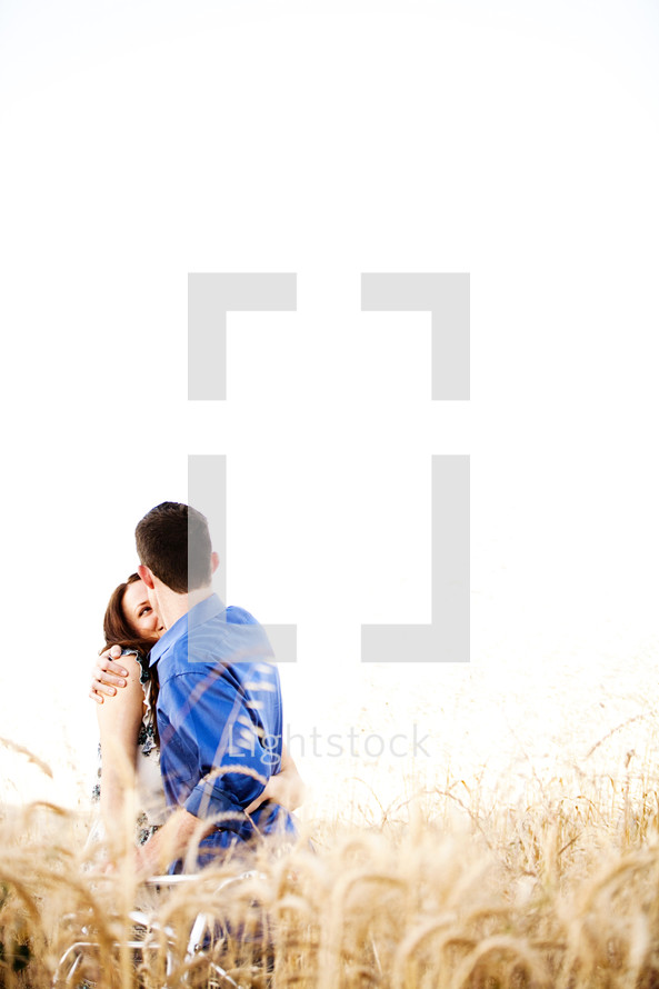 Happy couple embracing in wheat field