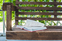 a Bible on a porch swing 