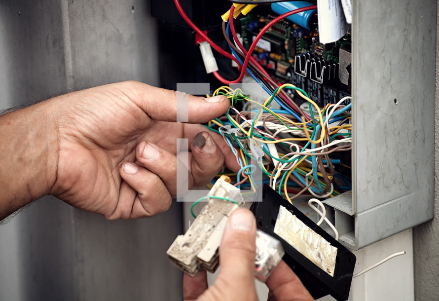 Electrician repairing electric system of an automatic gate