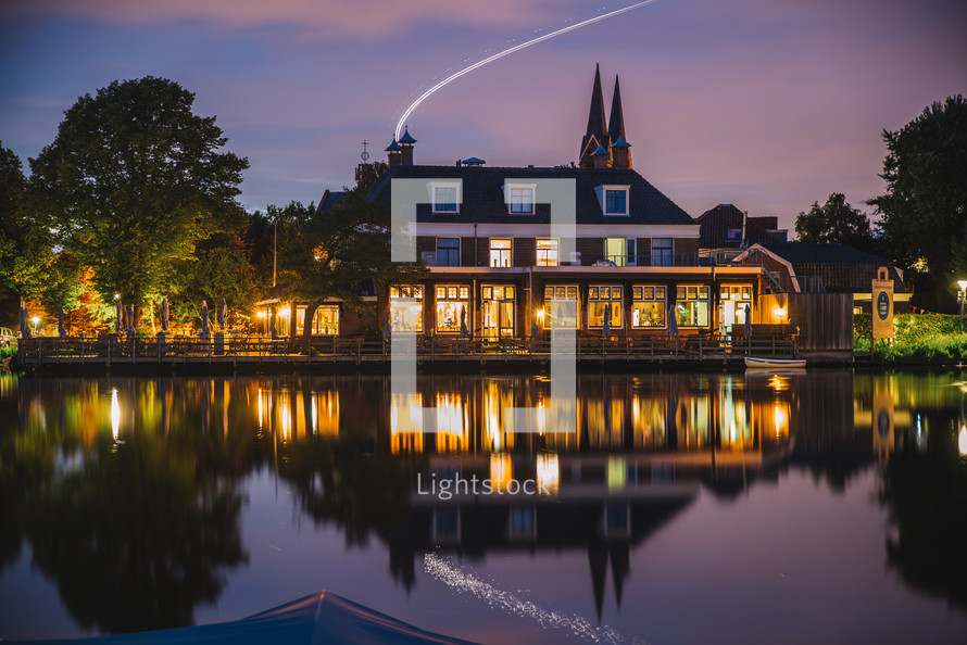House reflections in a lake in the evening