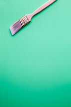 Paint brush at the top of a green background.