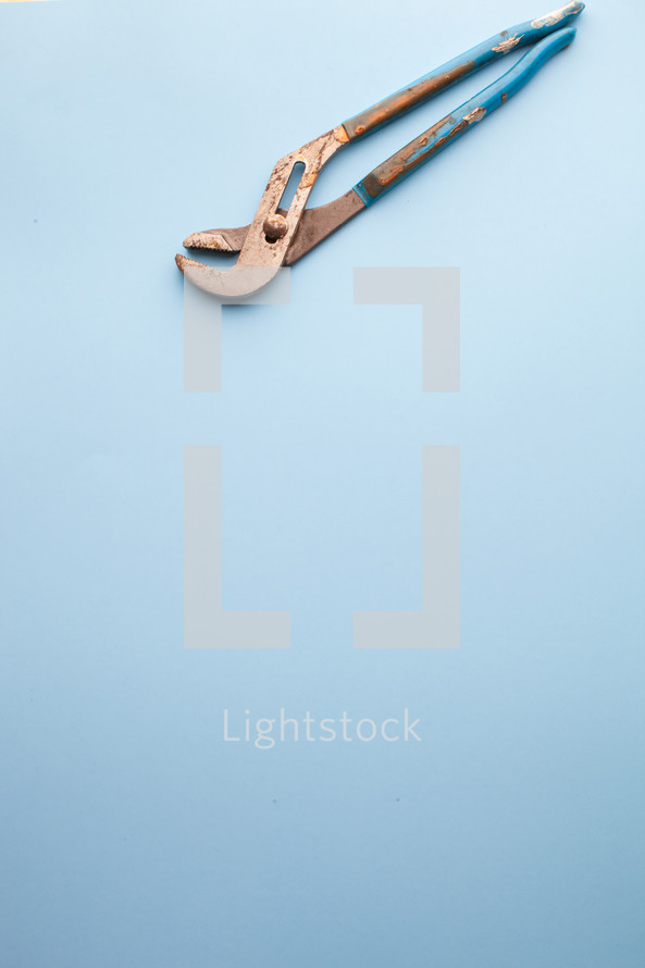Crescent wrench at the top of a blue background.