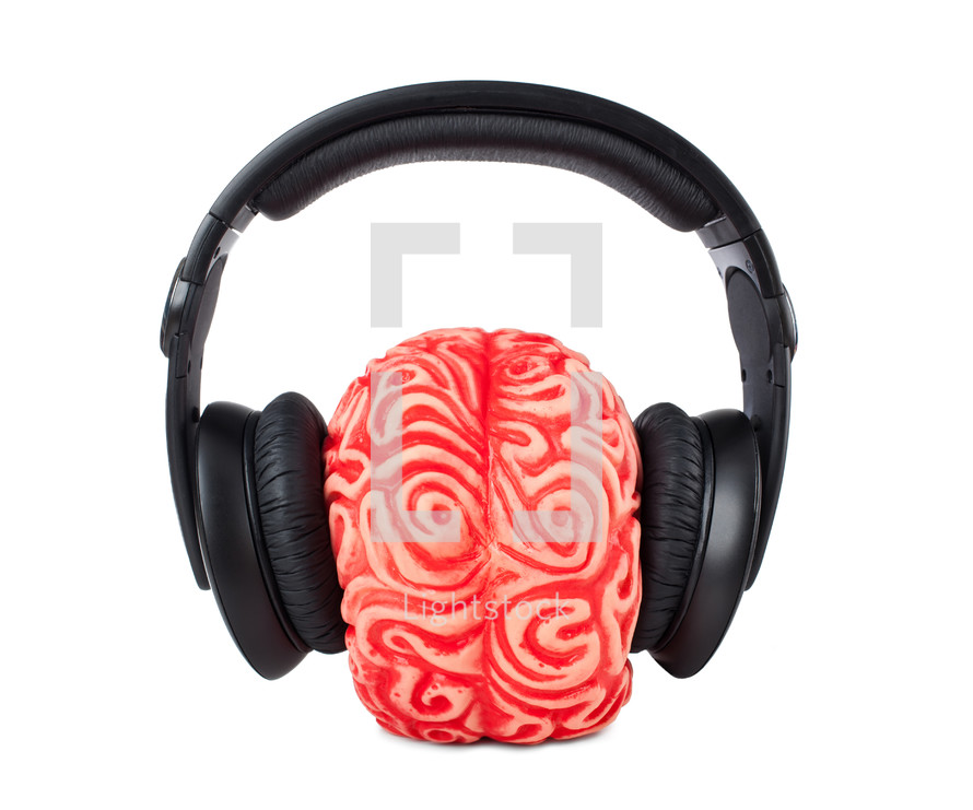 Human brain rubber with headphones on white background