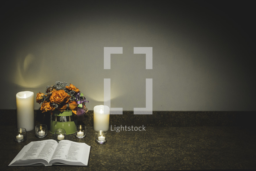 candles and an open Bible