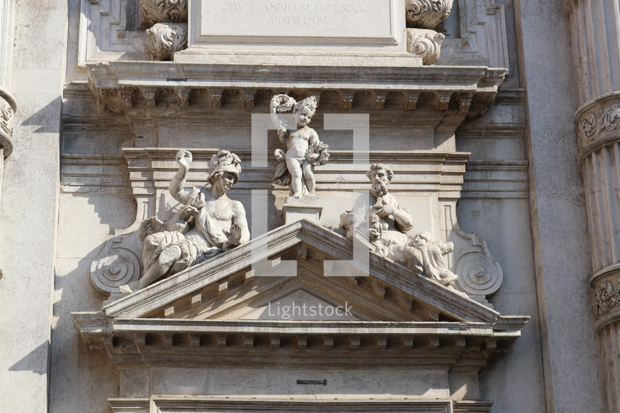 statues in stone on over a doorway 