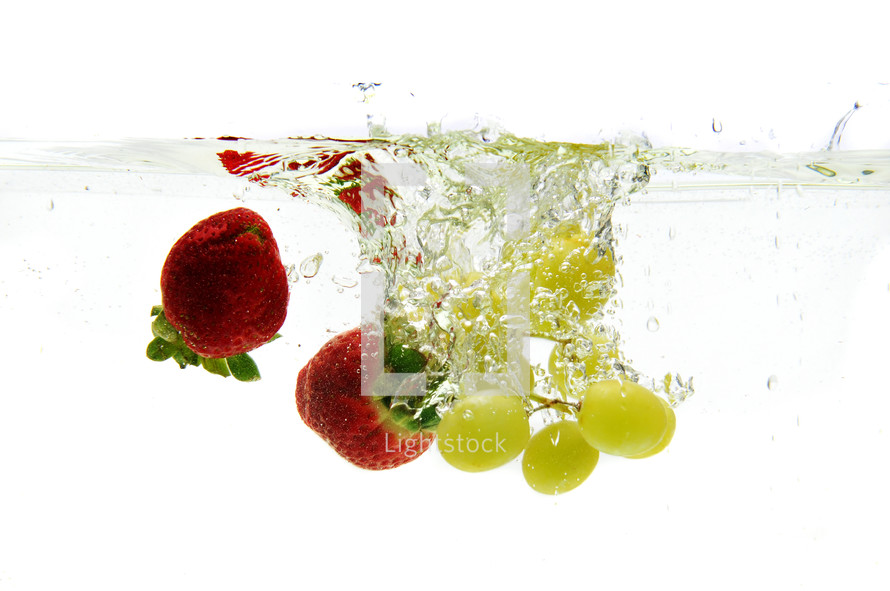 strawberries and grapes under water 