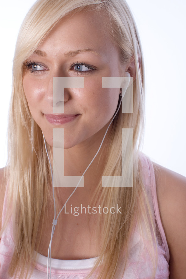 young woman listening with earbuds 