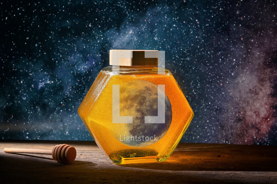 Abstract Honeymoon. Moon On A Jar with Honey on Wooden Table