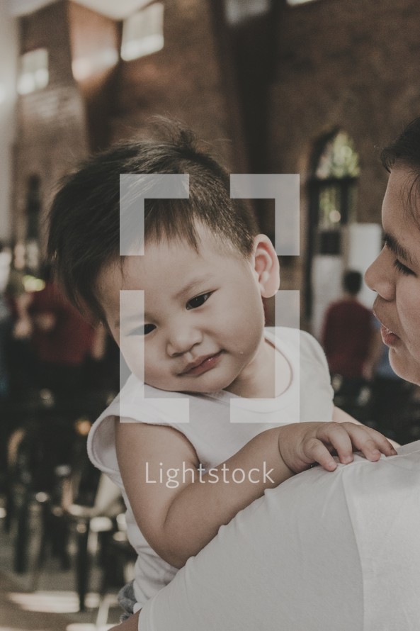 mother holding an infant at church 