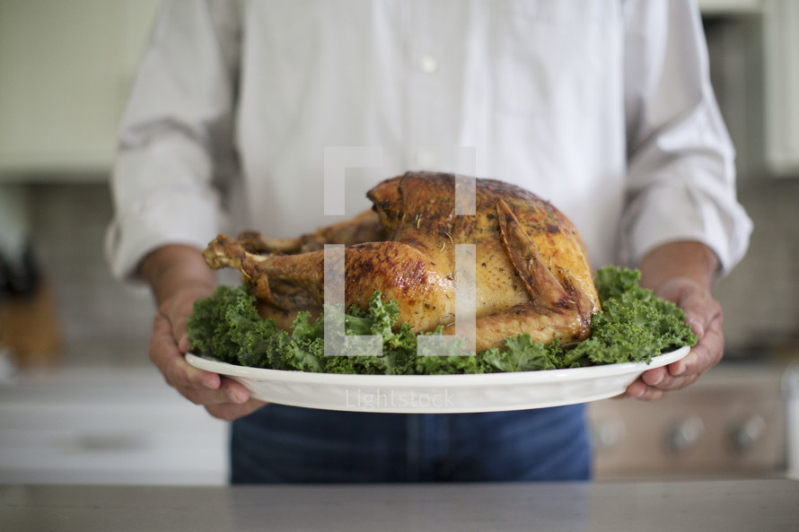 a man holding a Thanksgiving turkey 