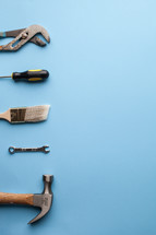 Tools lined up on the left side of a blue background.