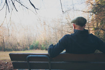 man sitting on a bench relaxing 