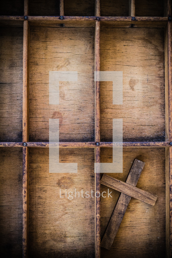 cross on wood shelves 