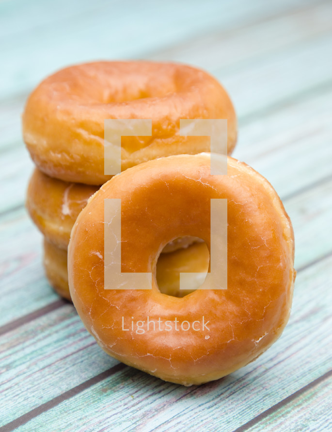 stacked donuts on a wood background 