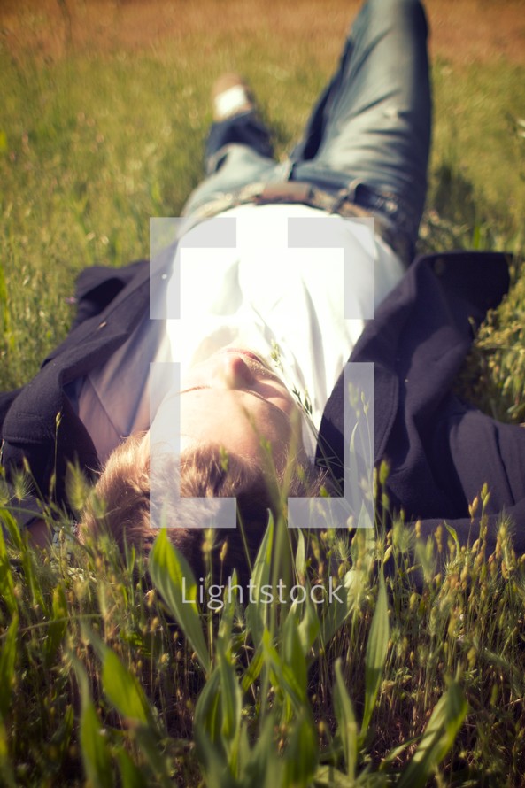 man lying in grass