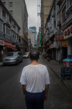 a man standing in an alley in China 